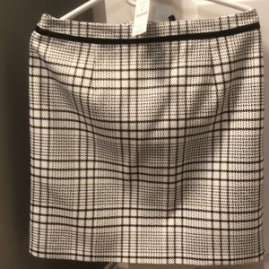 Never worn skirt hangs right above the knee.